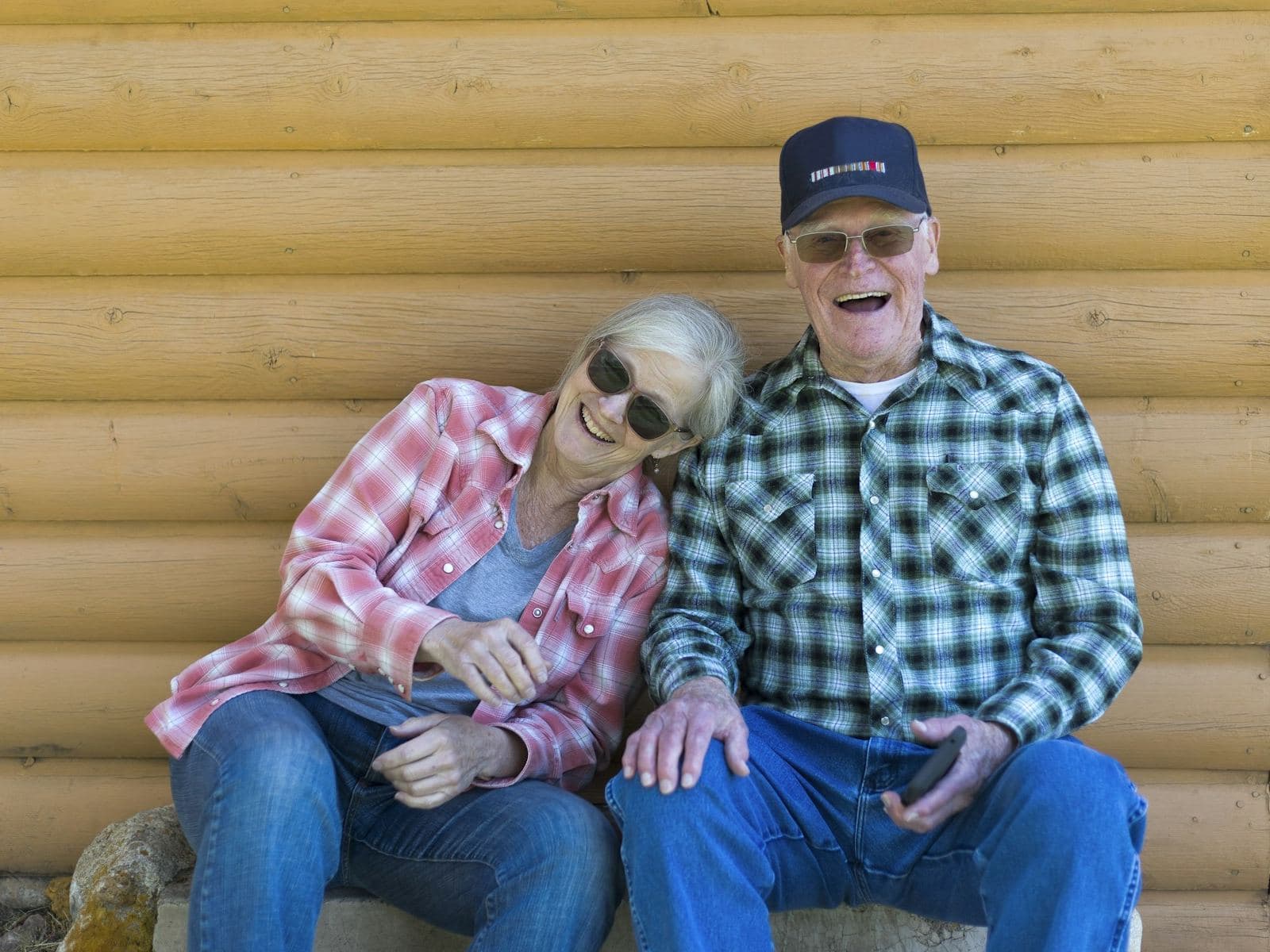 Senior couple laughing on a cottage porch