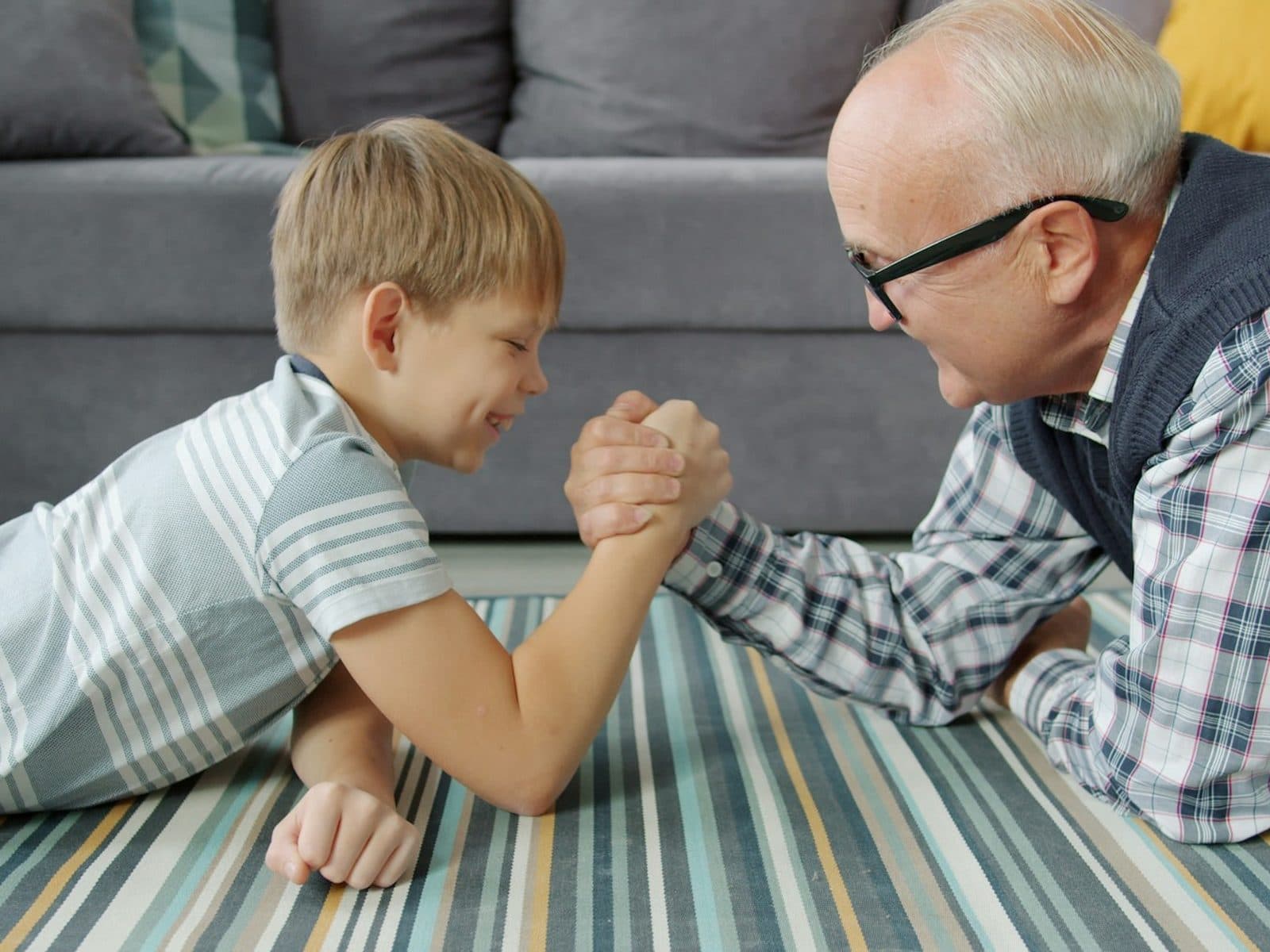 Grandfather and grandson arm wrestling